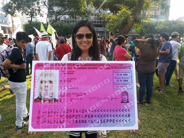 Professor María Eugenia Ulfe (Pontifical Catholic Univ. of Peru) holds up an enlarged ID card created by Peruvian artist and activist Giuseppe Campuzano (1969–2013) during an April 2014 rally in support of gay marriage in Lima. The ID belongs to Campuzano’s DNI (De Natura Incertus) collection in Museo Travesti del Perú. Karen Bernedo